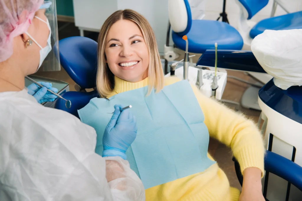 Smiling woman sitting in a dental chair during a checkup